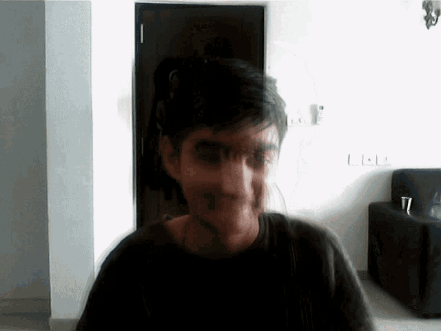 a blurry picture of a man 's face with the letter l visible
