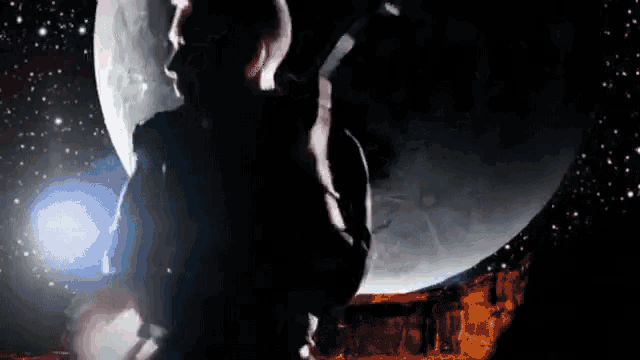 a silhouette of a man standing in front of a moon
