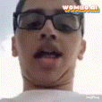 a close up of a man wearing glasses and a white shirt with the word wow on the bottom