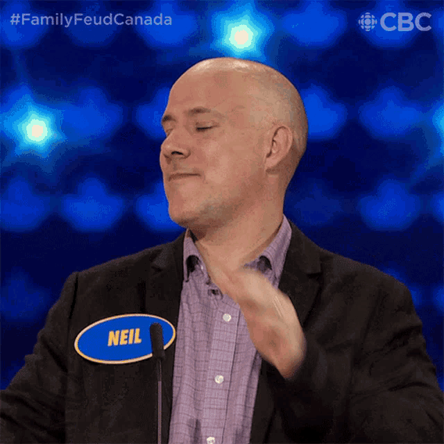 a man wearing a name tag that says neil on it