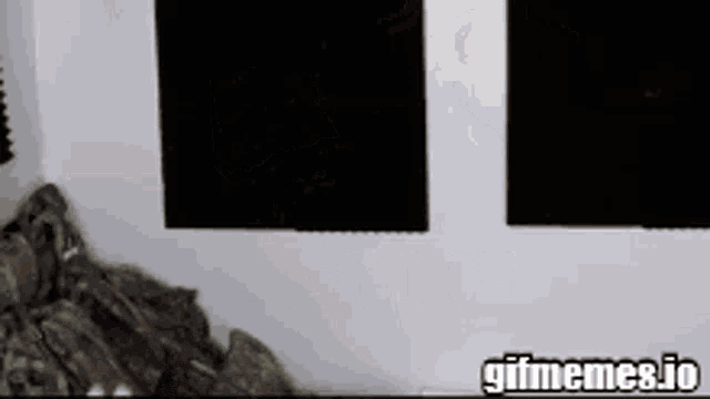 a group of soldiers are standing in a room with a gif meme.io logo on the bottom right corner .