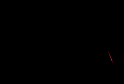 a red light is shining on a dark surface