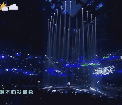 a man in a white shirt is standing on a stage with chinese writing on the bottom