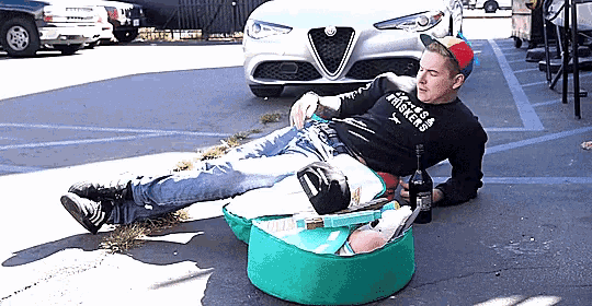 a man laying on the ground wearing a shirt that says ' locked & triggered '