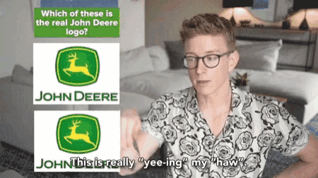 a man sitting in front of a john deere logo and a john this is really yee-ing my haw sign