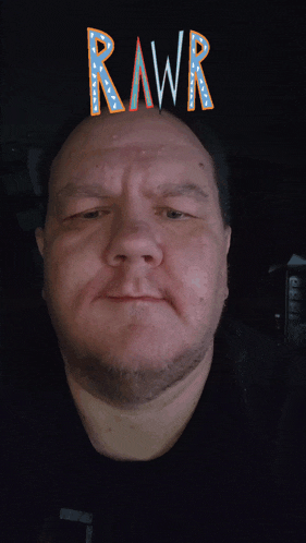 a man making a funny face with the word rawr above his head
