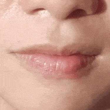 a close up of a woman 's lips and nose without makeup .