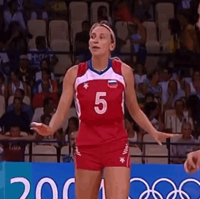 a woman in a volleyball uniform with the number 5 on it