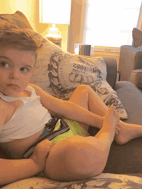two children sit on a couch in front of a pillow that says 1862