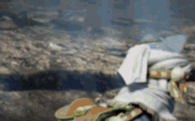 a blurred image of a person sitting on a rock .