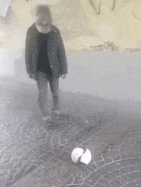 a person is kicking a soccer ball on the ground