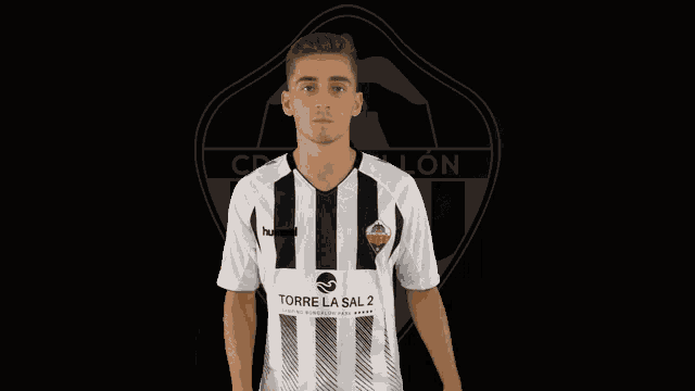 a man wearing a black and white striped shirt with torre la sal 2 on it