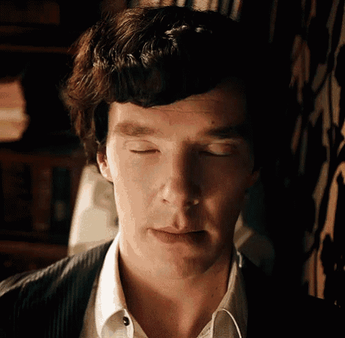 a close up of a man 's face with closed eyes