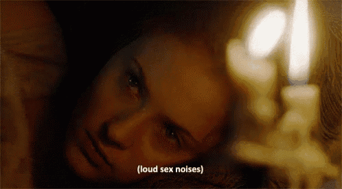 a woman is laying in front of a lit candle with the words " loud sex noises " written below her