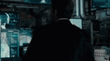 a man in a suit is holding a red and white pokeball in front of his face