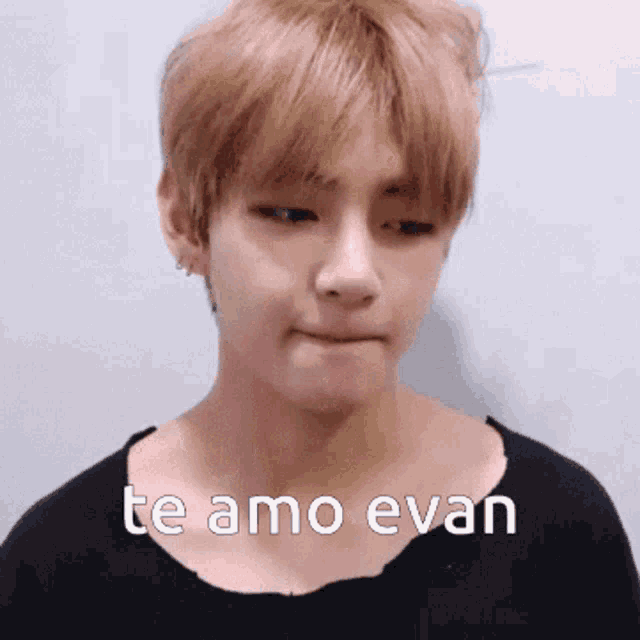 a young man wearing a black shirt with the words te amo evan on it