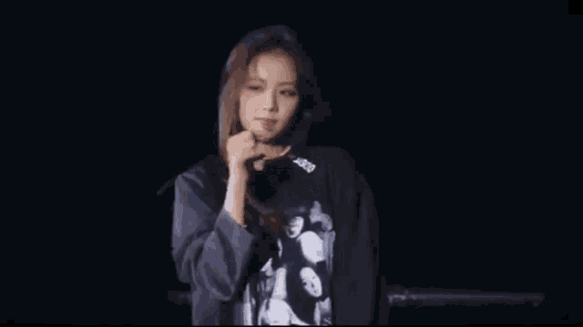 a blurry picture of a woman in a black shirt waving