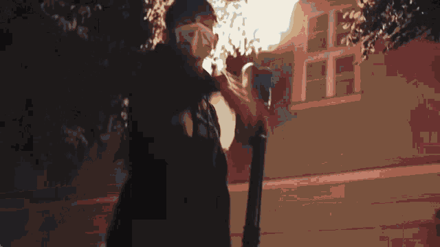 a man wearing a mask is standing in front of a building