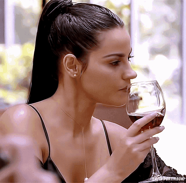 a woman drinking a glass of wine with the word portthorne on the bottom of the image