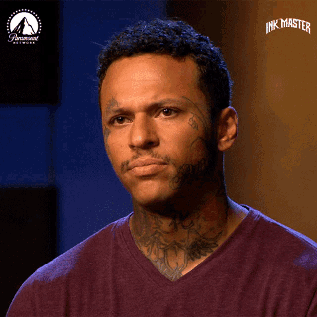 a man with a tattoo on his face is making a face in front of a paramount network logo