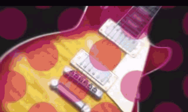 a close up of a pink and yellow guitar with a purple background