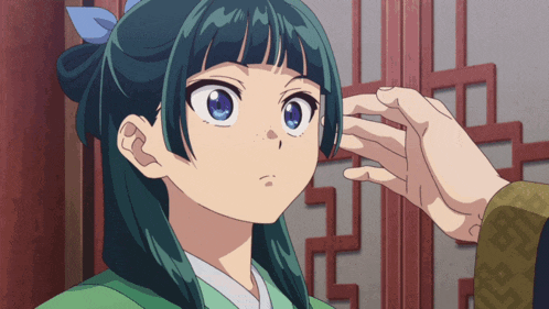 a person touches a girl 's face with their finger