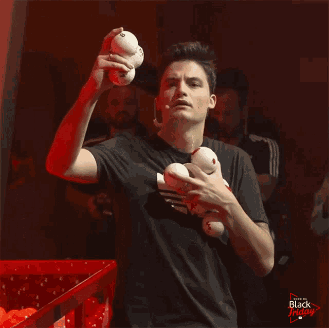a man in a black shirt is juggling balls and the words black friday are on the bottom