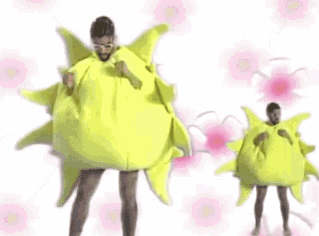 a man is standing next to another man in a sun costume .