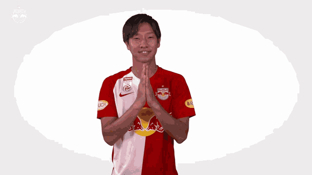 a man wearing a red and white jersey with the red bull logo on it