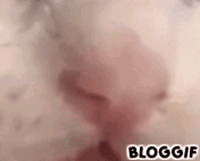 a blurry picture of a person 's face with the words bloggif written on the bottom