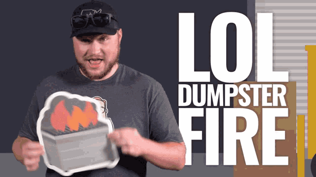 a man wearing a hat and goggles is holding a tray with the words lol dumpster fire on it