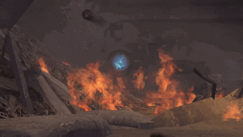 a person is giving a thumbs up in front of a large fire