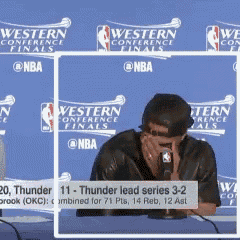 a man is covering his face while talking into a microphone during a western conference finals press conference