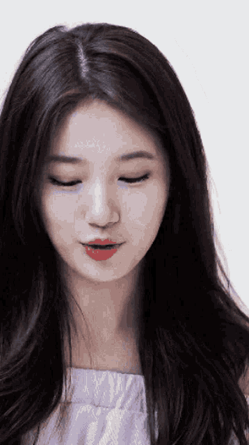 a close up of a woman 's face with her eyes closed and red lipstick