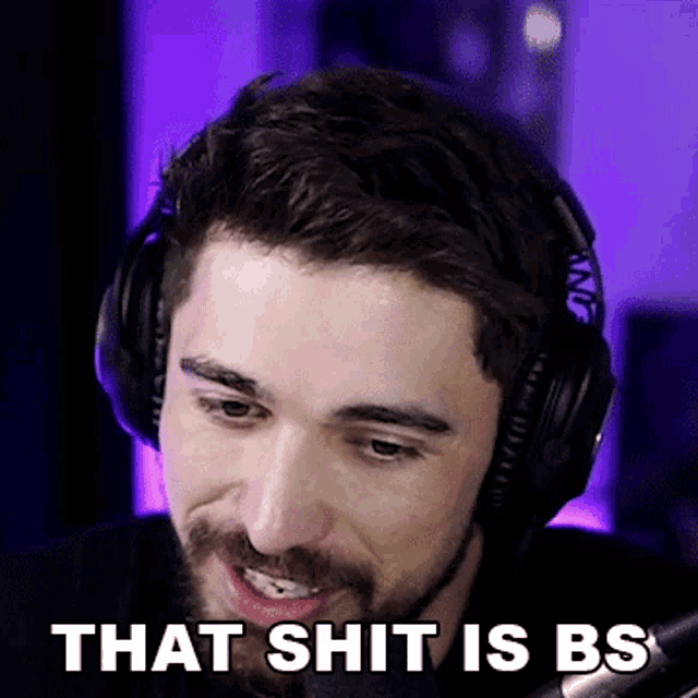 a man wearing headphones says " that shit is bs " in front of a microphone