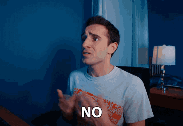a man in a white shirt says " no " with his hands