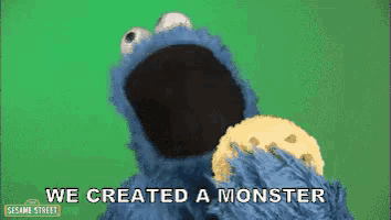 cookie monster from sesame street is holding a cookie in his mouth