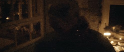 a blurred image of a person in a dark room