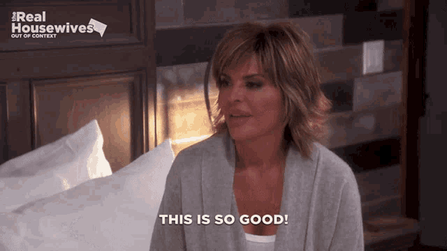 a woman says this is so good in front of a real housewives sign