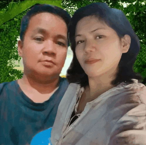 a man and a woman are posing for a picture in front of trees