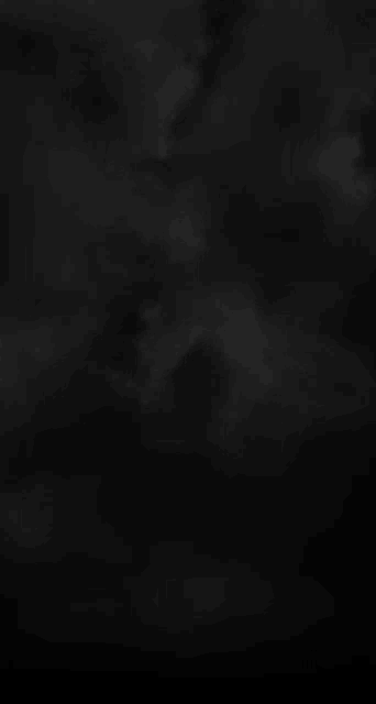 a black background with white clouds in it