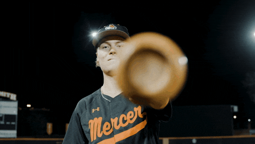 a mercer baseball player holds a bat in his right hand