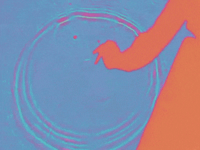 a person 's hand is reaching into a pool of water with a pink and blue background