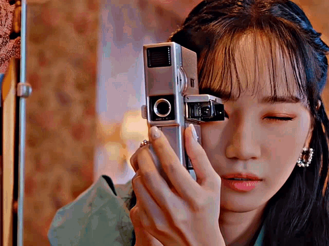 a woman is taking a picture with a camera that says ' o ' on it