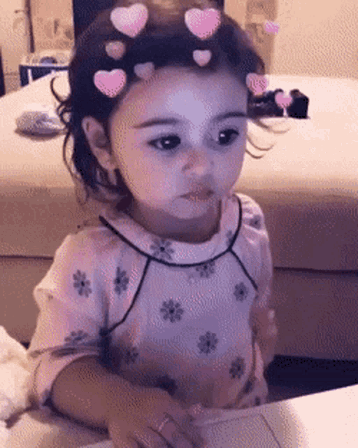 a little girl with hearts in her hair