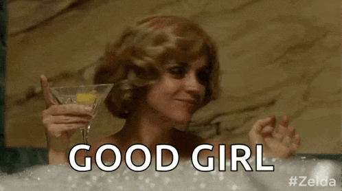 a woman is taking a bath and holding a martini glass and a bottle of alcohol .