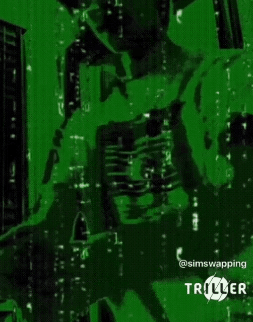 a person in a green shirt is standing in a room