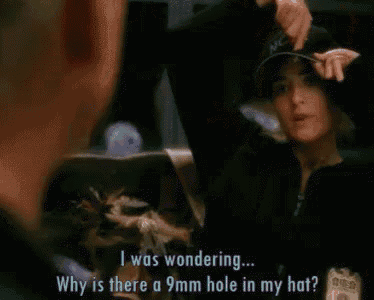 a woman wearing a hat is asking why is there a 9mm hole in my hat