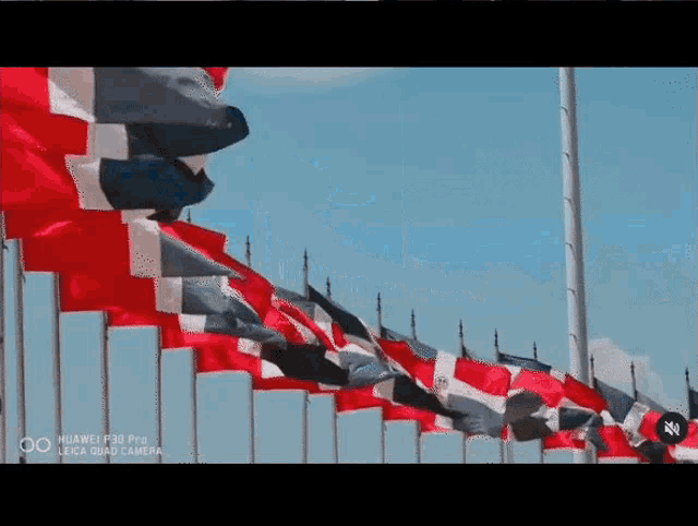 a huawei p30 pro leica quad camera shows a row of flags waving in the wind