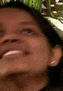 a close up of a woman 's face with her mouth open and a blurry background .